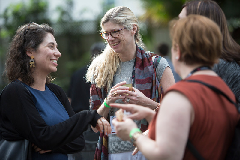 four people chatting and smiling