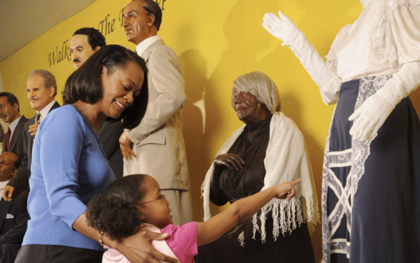 A photograph of an adult and child looking at an exhibit at the Museum fo Great Blacks in Wax