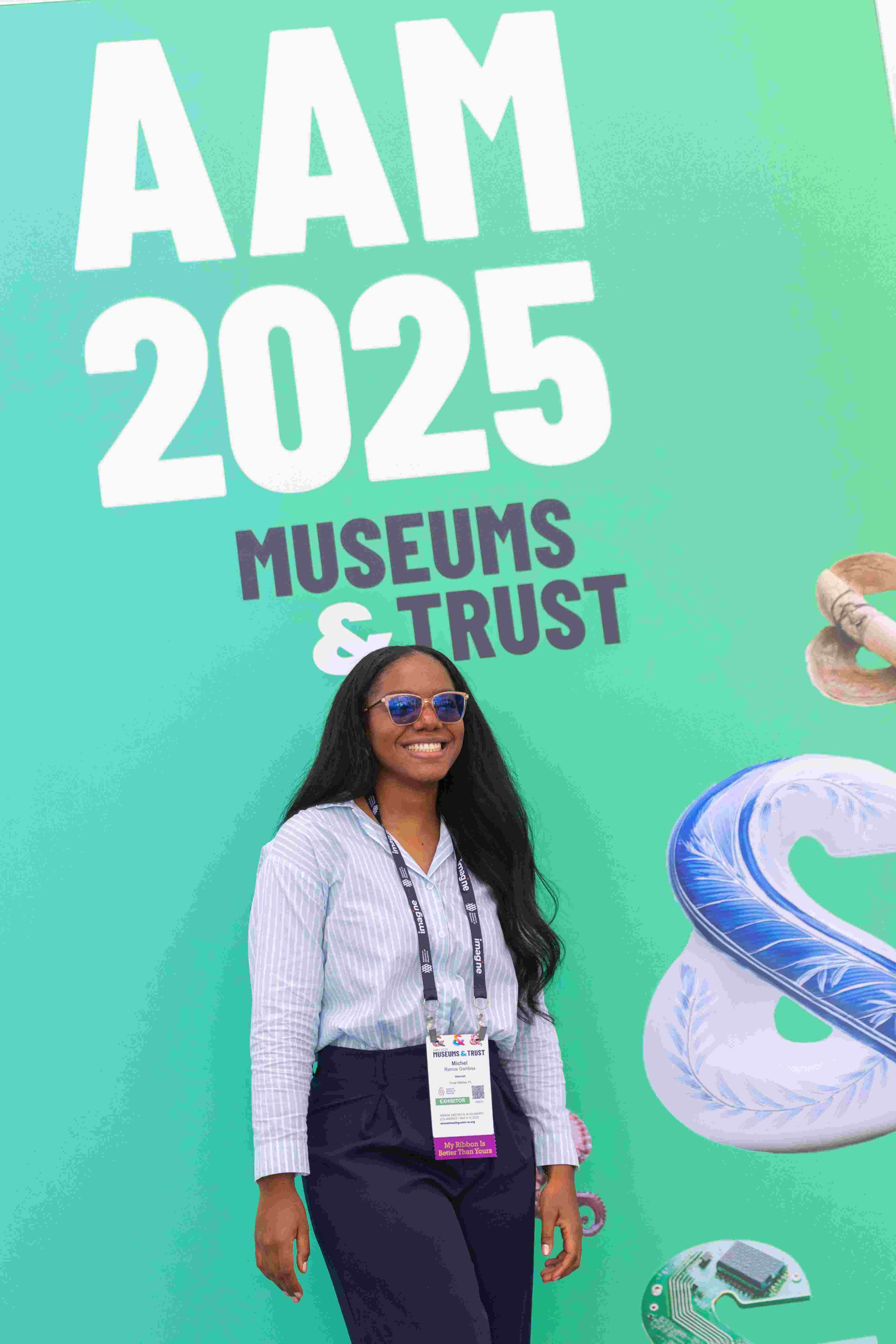 An attendee smiles under the AAM 2025 banner