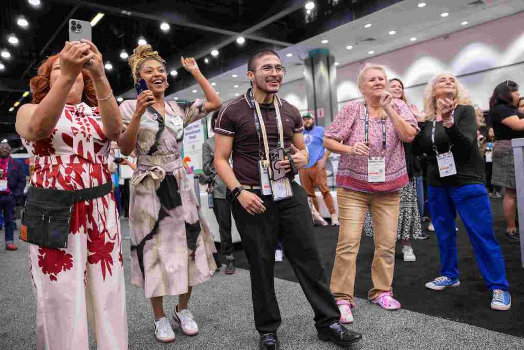 Attendees cheer on people dancing