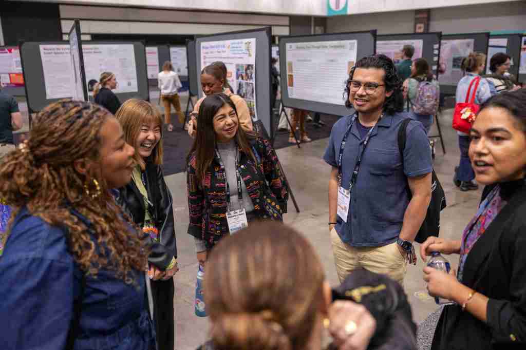 A group of people in a circle having a conversation in the expo hall