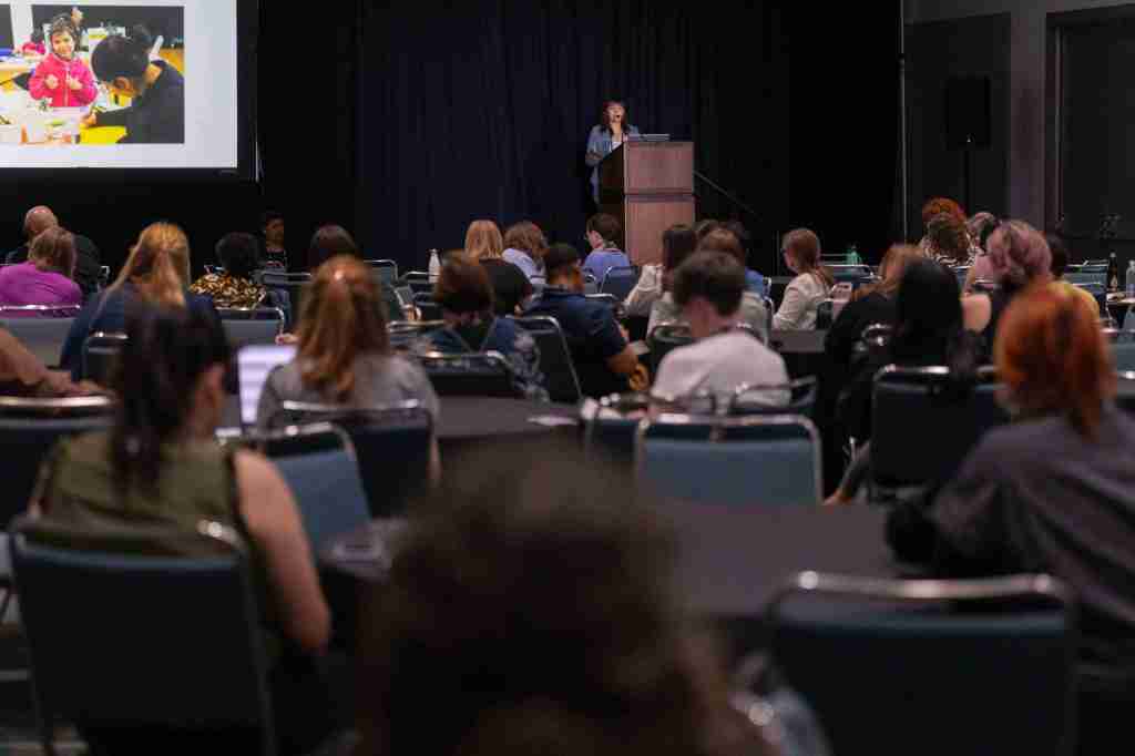 A large group of people in a session room