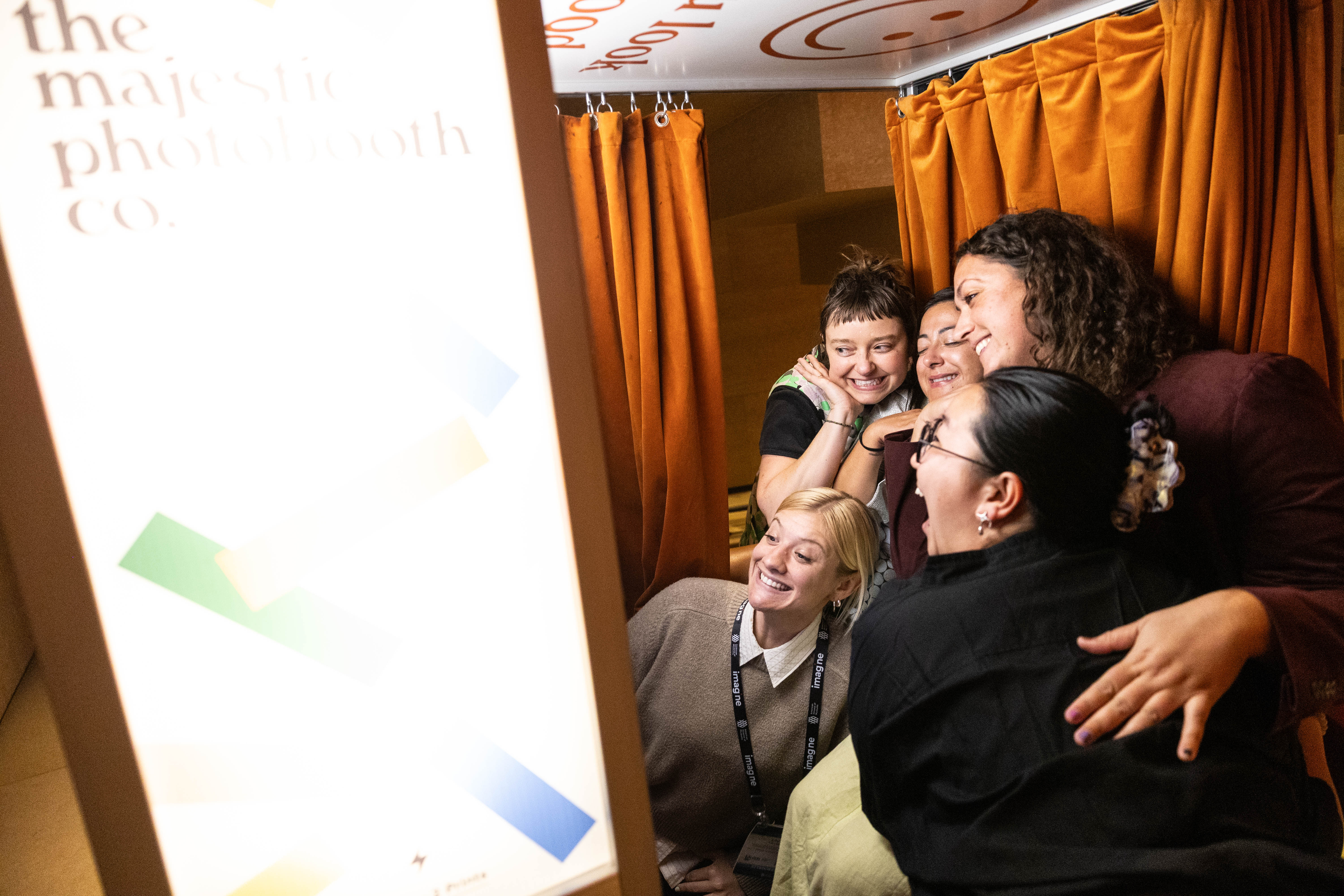 A group of attendees in a photo booth at the Franklin Institute party