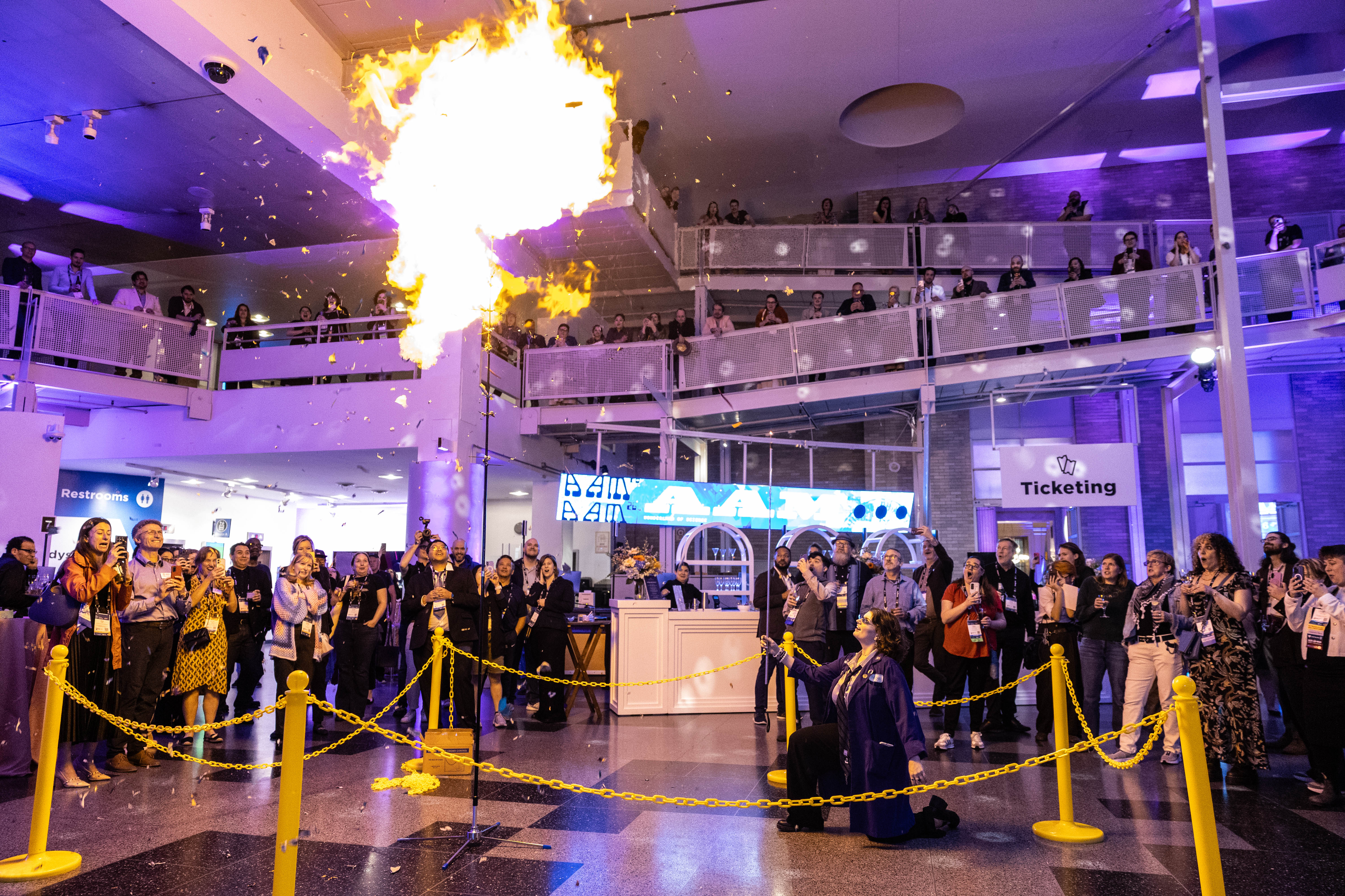 A scene from the AAM Party at the Franklin Institute during which a science educator create a giant fire ball from setting helium balloons on fire.