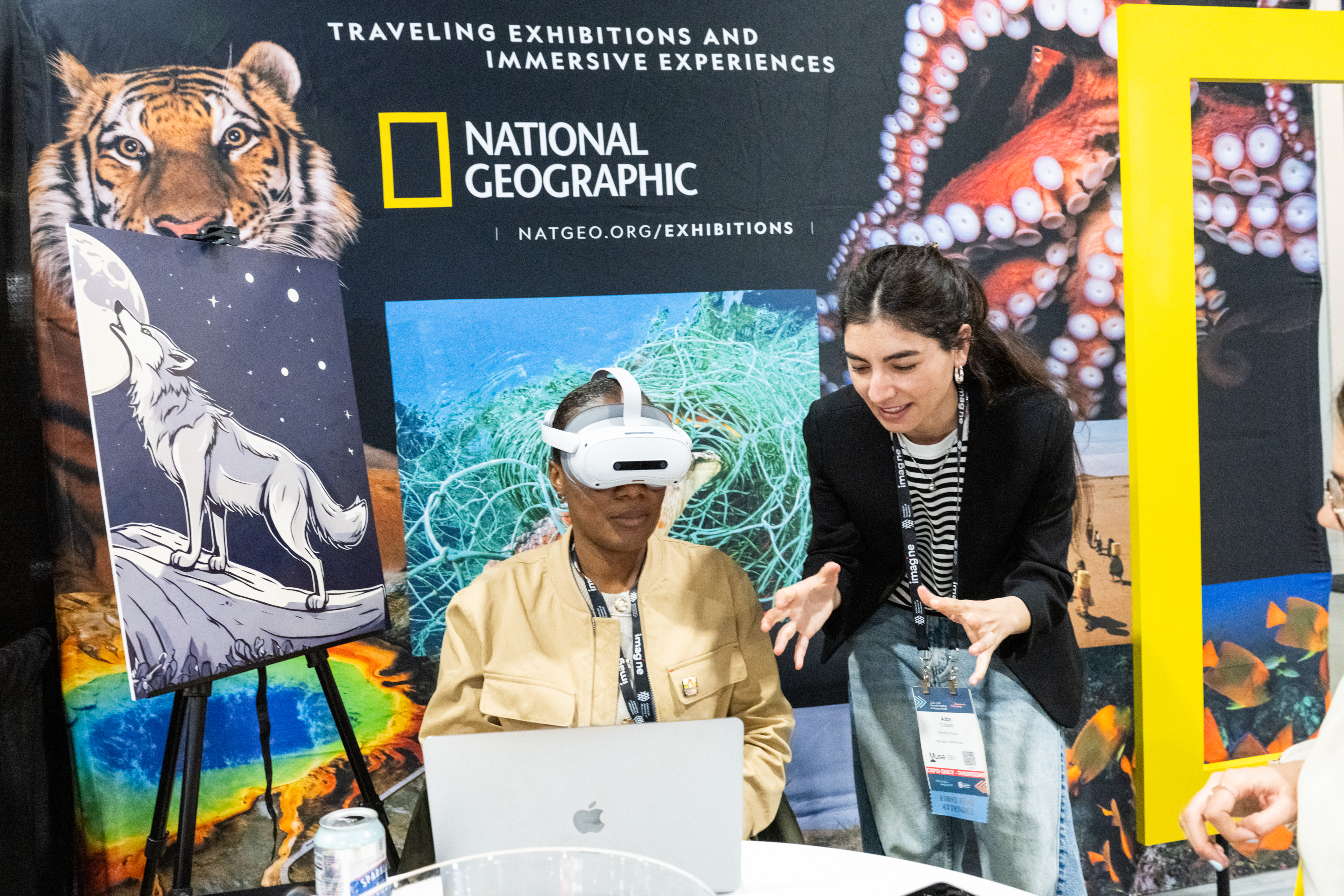 A person trying on a VR headset at the National Geographic traveling exhibitions booth